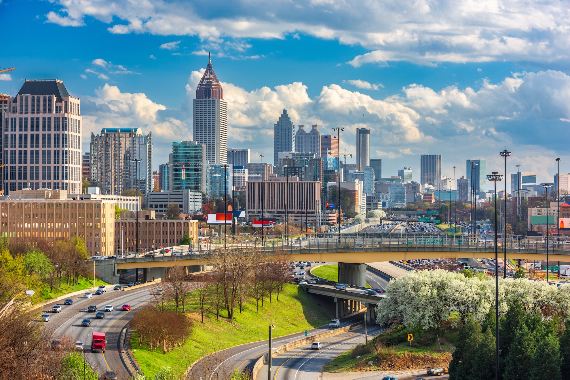 Atlanta, Georgia downtown skyline with Midtown skyscrapers and highway interchange on a sunny day