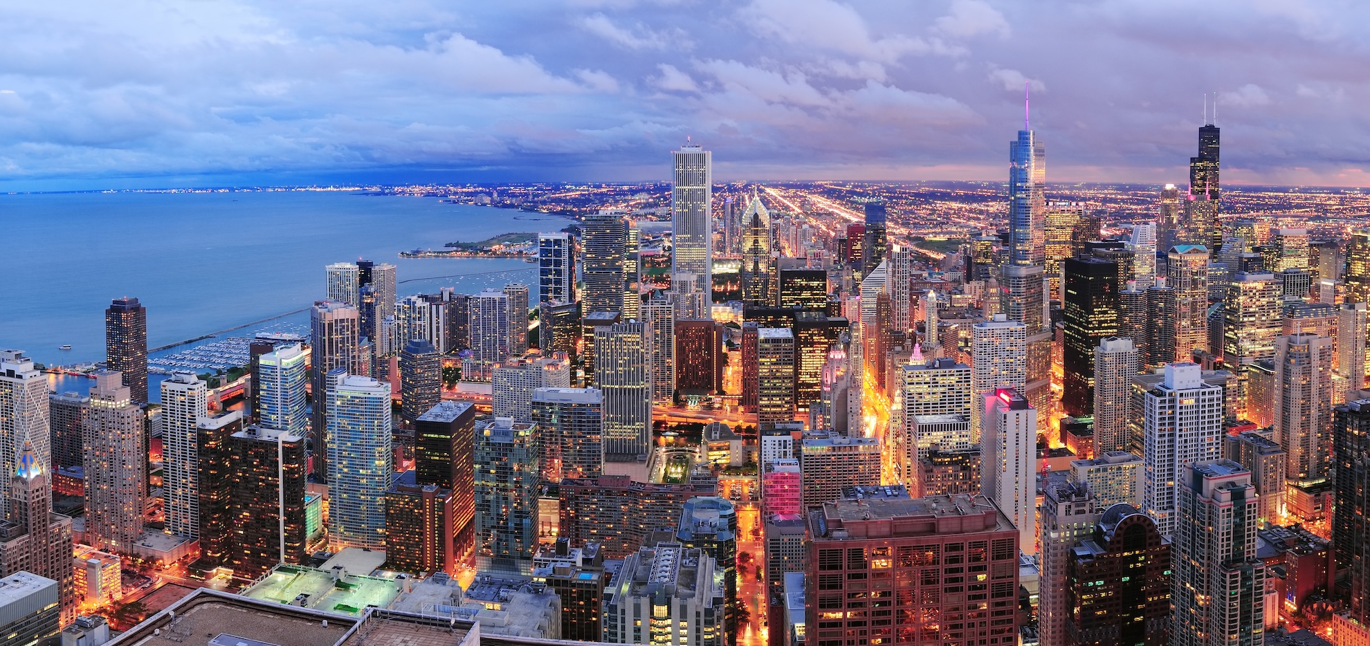 Aerial panorama of Chicago skyline and skyscrapers along Lake Michigan at dusk