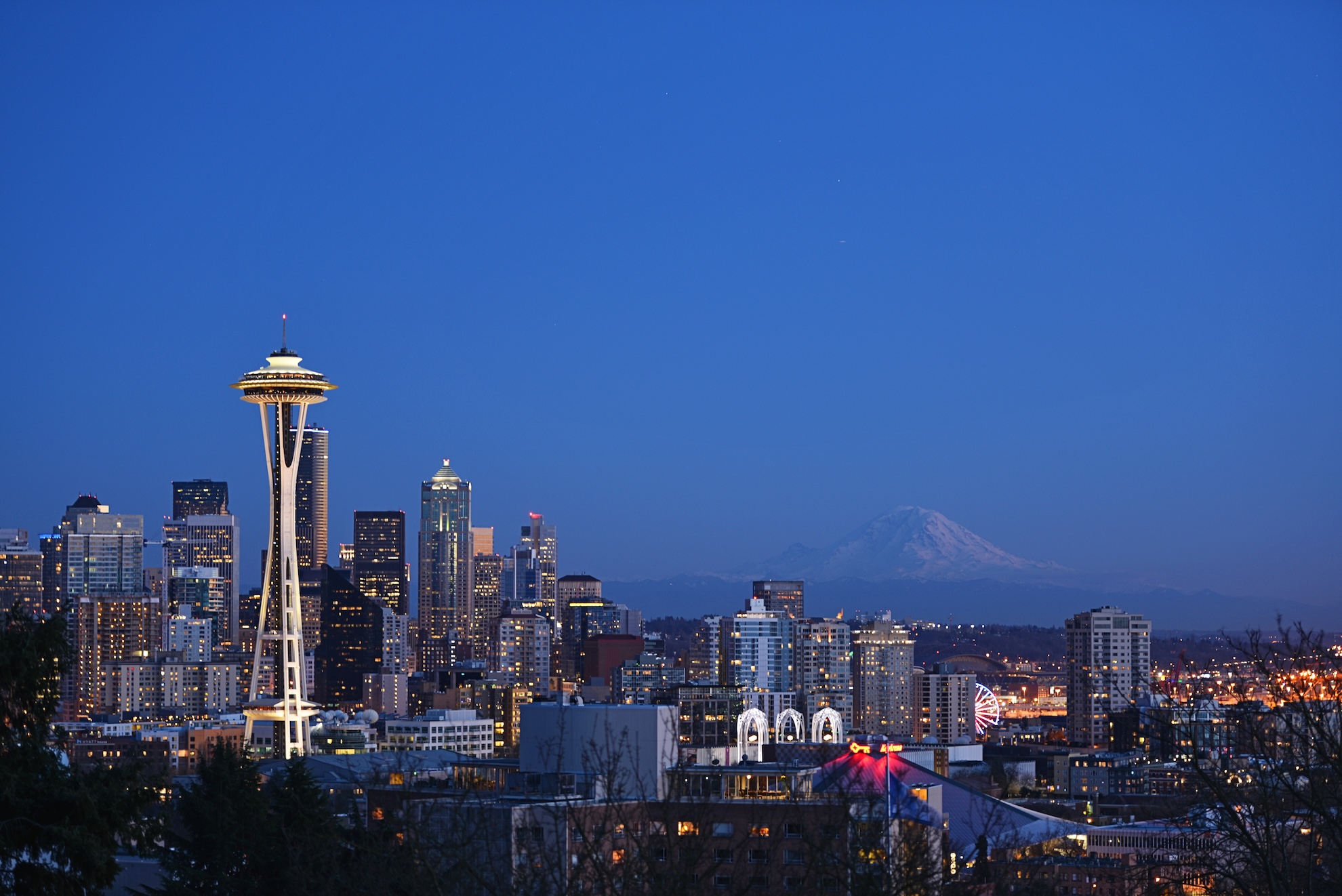 Seattle, Washington skyline at dusk with the Space Needle and Mount Rainier in the background