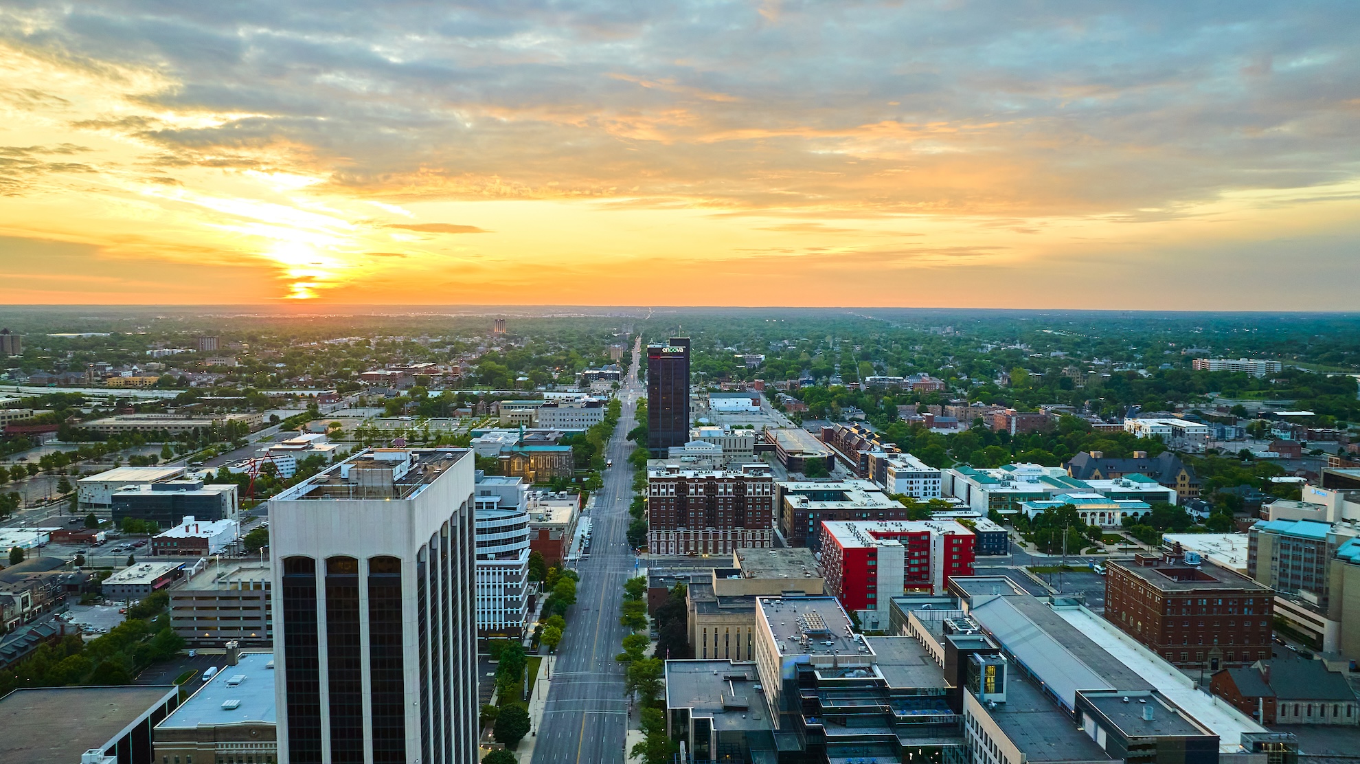 Aerial view of downtown Columbus, Ohio at sunrise with golden sky over city buildings